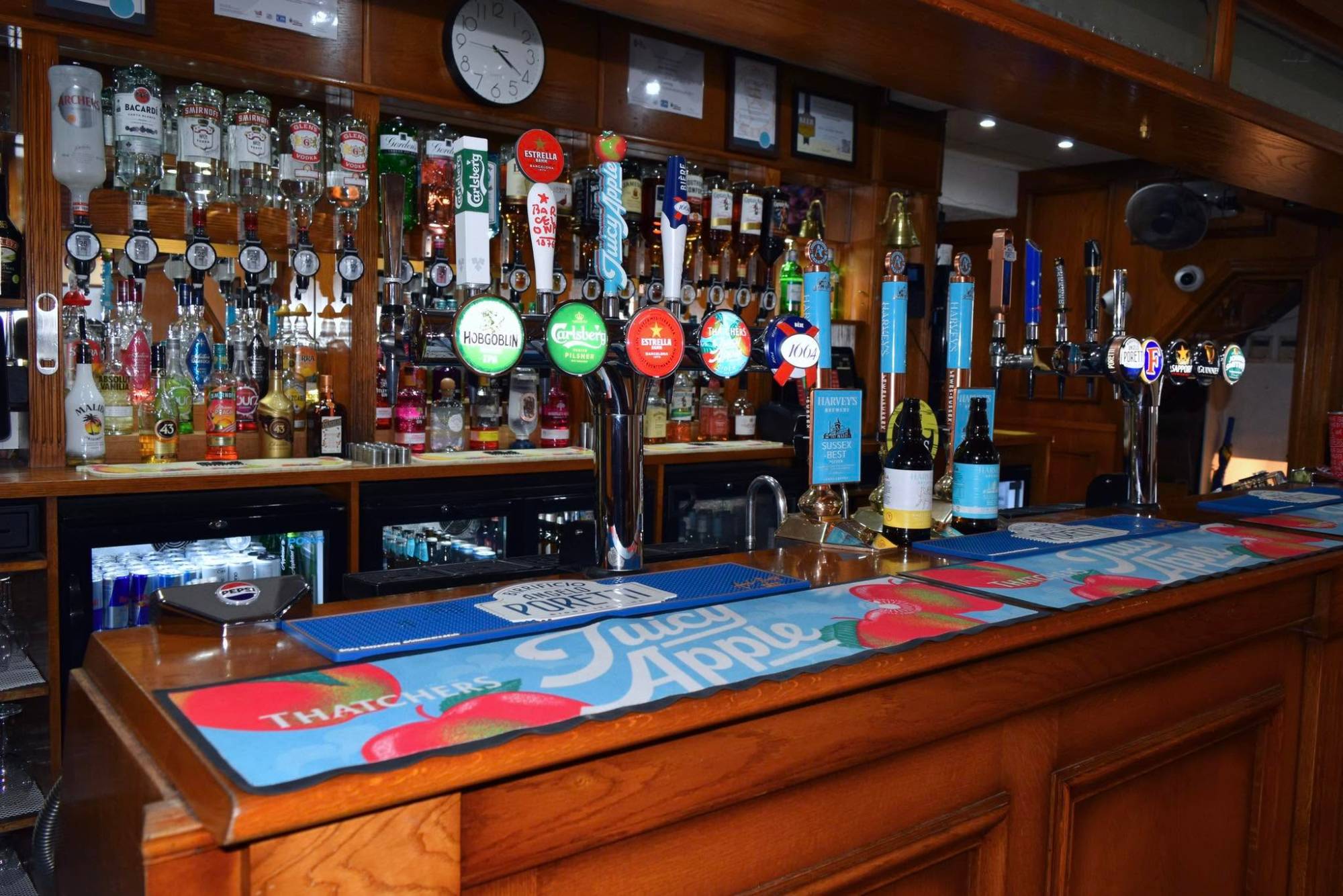 The club bar: lager and cider taps, Harvey’s Sussex Best on hand pull, and spirits on the back bar